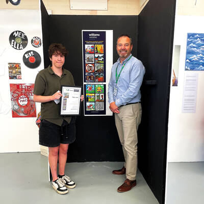 Coleg Llandrillo student Elgan Jones is presented with the winner’s certificate by Jason Williams, proprietor of Williams Estates