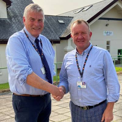 Dr Bryn Hughes Parry with Aled Jones-Griffith, Principal of Coleg Menai and Coleg Meirion-Dwyfor